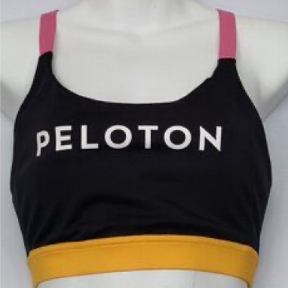 Peloton colorblock sports bra in black‎ with magenta straps and a yellow band